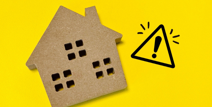 黄色の背景に家のパネルとびっくりマークが書かれている